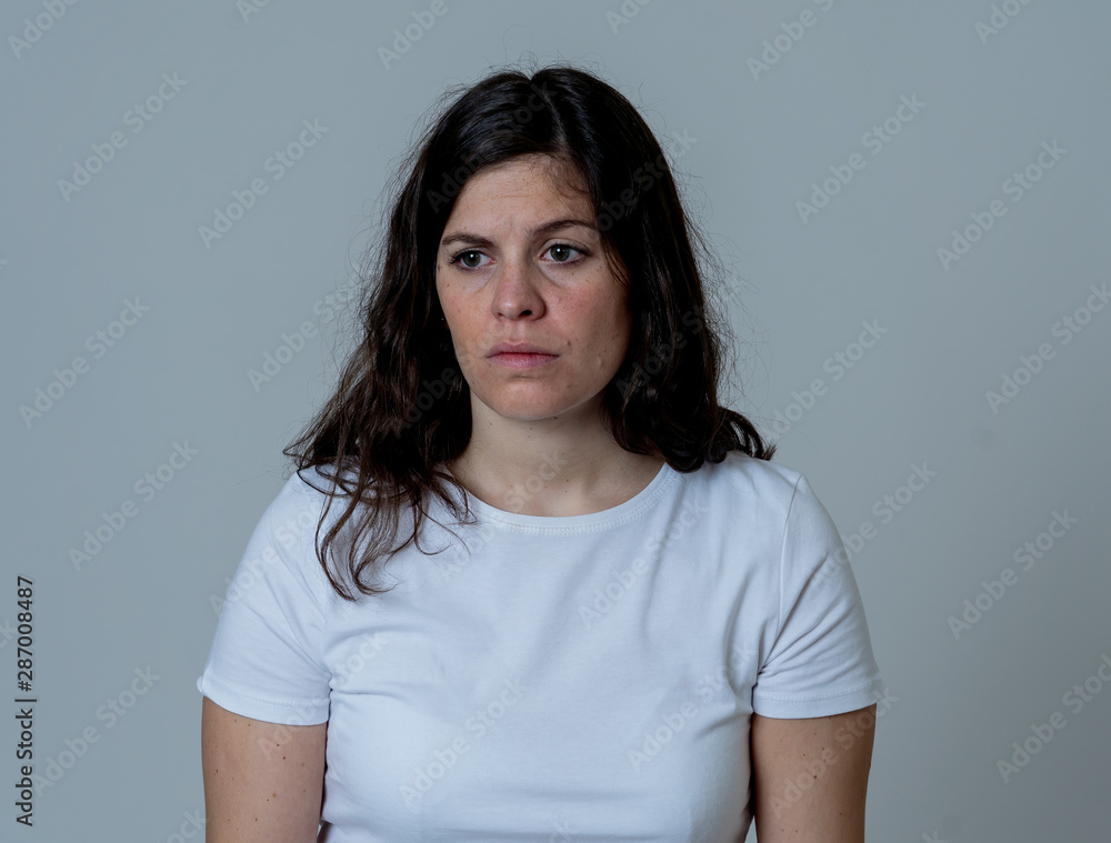 Portrait of sad and depressed woman. Isolated on neutral background. Human expressions and emotions Portrait of sad and depressed woman. Isolated on neutral background. Human expressions and emotions
