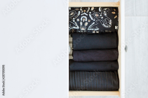 holiday womens clothing black sequin stored vertically in white wooden chest of drawers