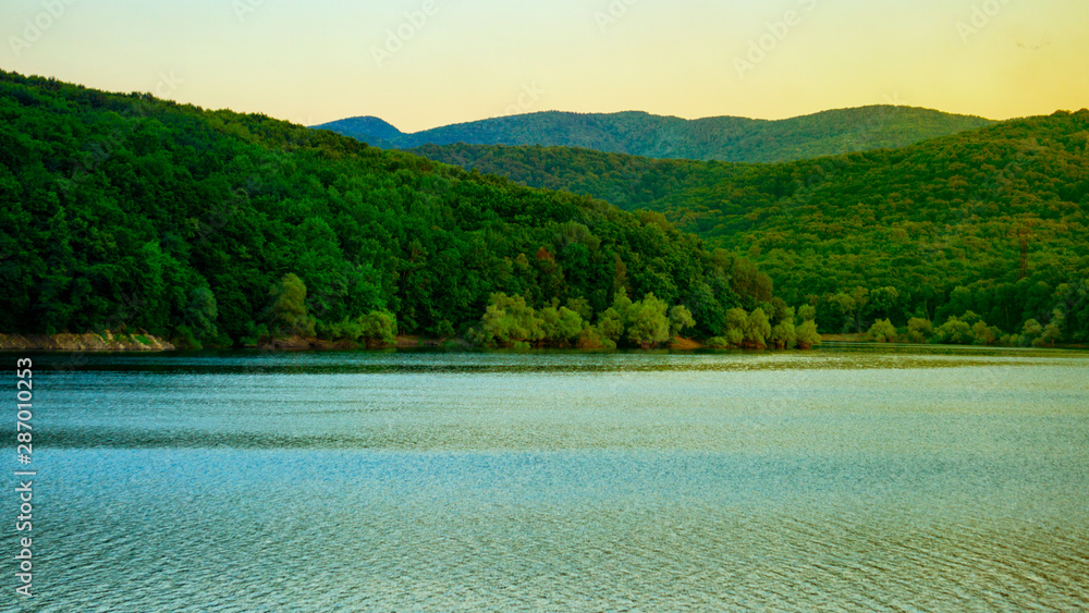 Freshwater lake among wooded mountains