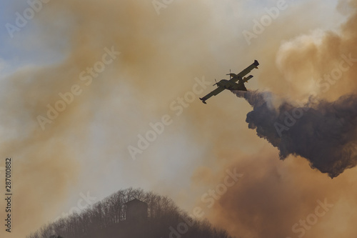 canadair in action on hills on fire photo