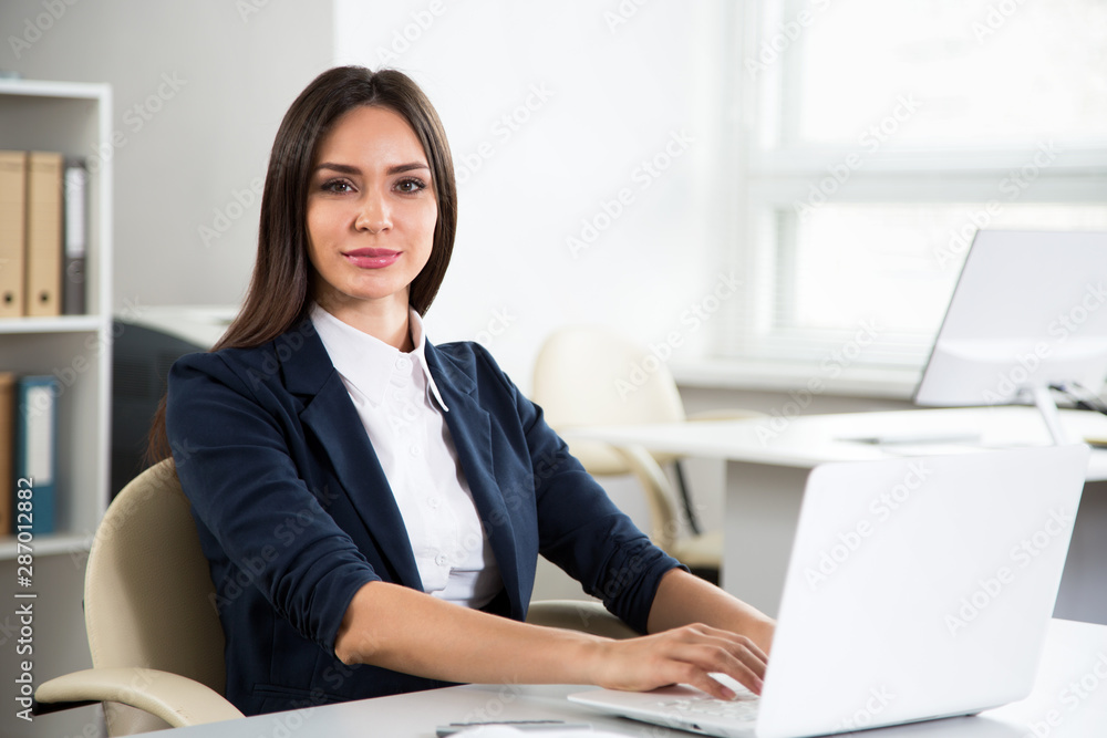 Portrait of businesswoman working with computer Portrait of businesswoman working with computer