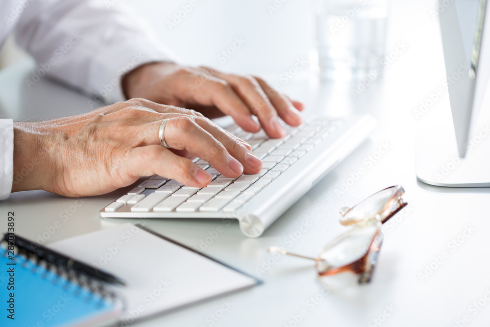 Close-up of businessman hands typing on the keyboard in an office Close-up of businessman hands typing on the keyboard in an office