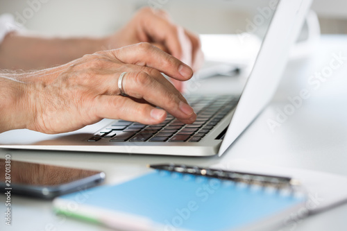 Closeup of businessman s hands working with laptop