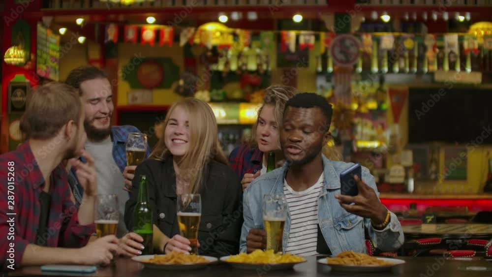 Group Of Happy Multiracial Friends Making A Toast With Beer At Bar Or Pub Group Of Happy Multiracial Friends Making A Toast With Beer At Bar Or Pub