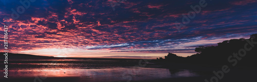 A beautiful transition between daylight and moonlight over an Australian beach.