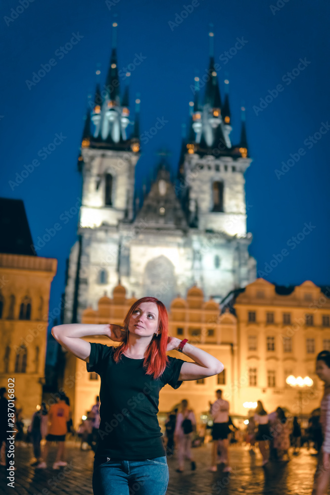 Woman, on the street of the old city of Prague, night time. historical center, square. travel and tour in Europe, tourism. vertical photo, Praha