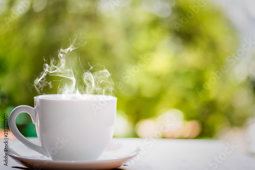 White coffee cup on top wooden table with blurred background