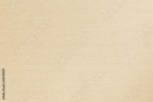 Cotton fabric woven textile textured background in yellow gold cream beige color .