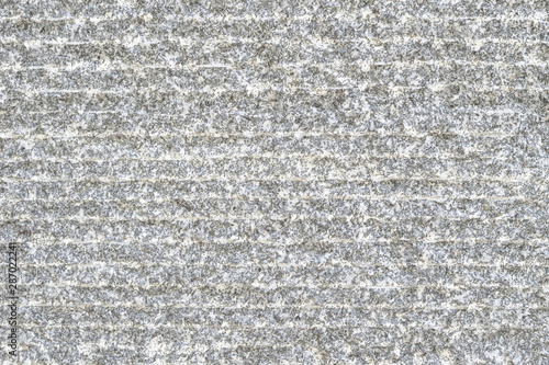 Granite stone texture with modern grooved patterned background in natural grey color
