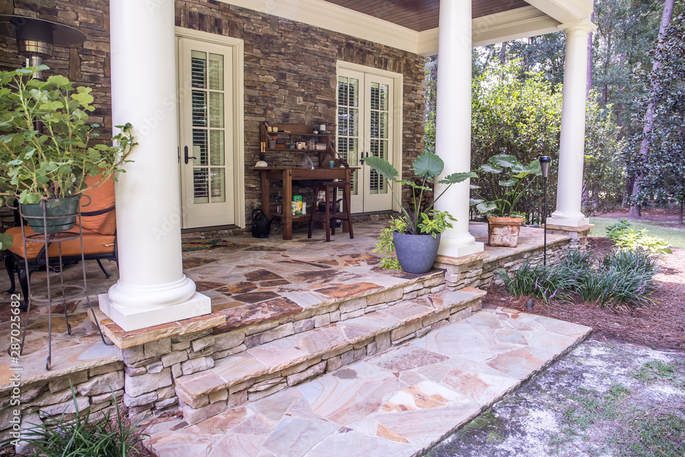 Φωτογραφία Outdoor Stone Patio Porch of large home estate with seating