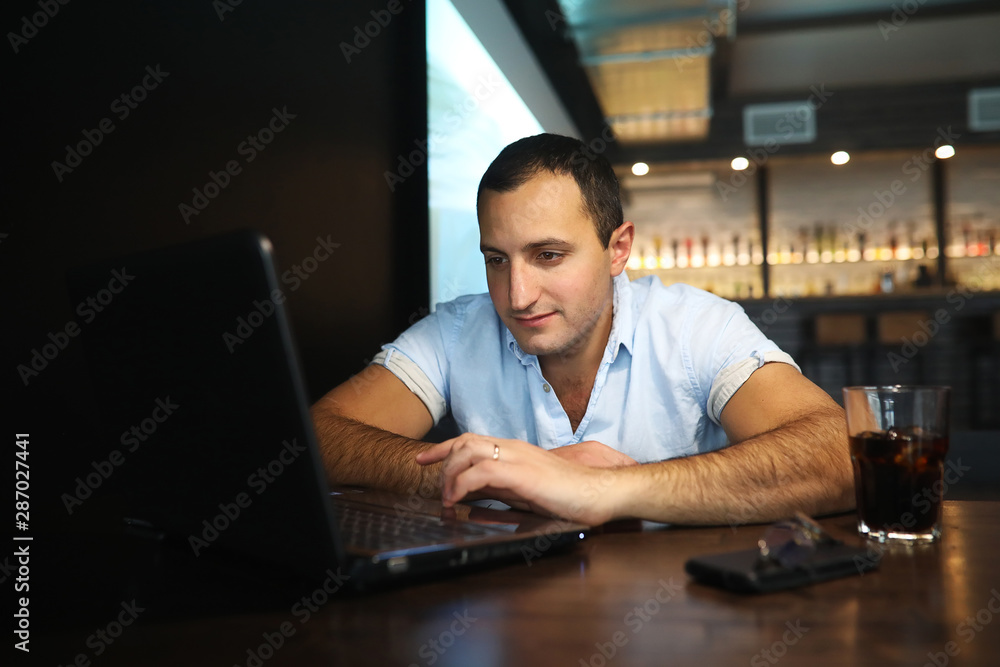 Armenian handsome man working behind laptop Armenian handsome man working behind laptop