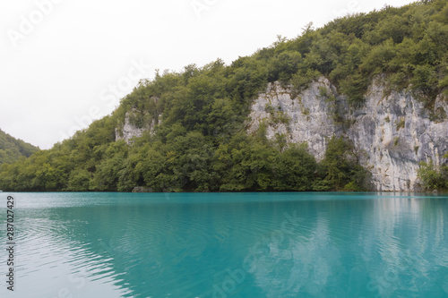 Blue clear lake view with the mountains and trees view in Plitvice lakes national park, Croatia - Image