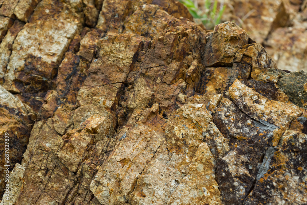 Background of granite. Texture of granite stone. Pattern of roughened surface. Texture of brown stone or rock with minerals Background of granite. Texture of granite stone. Pattern of roughened surface. Texture of brown stone or rock with minerals