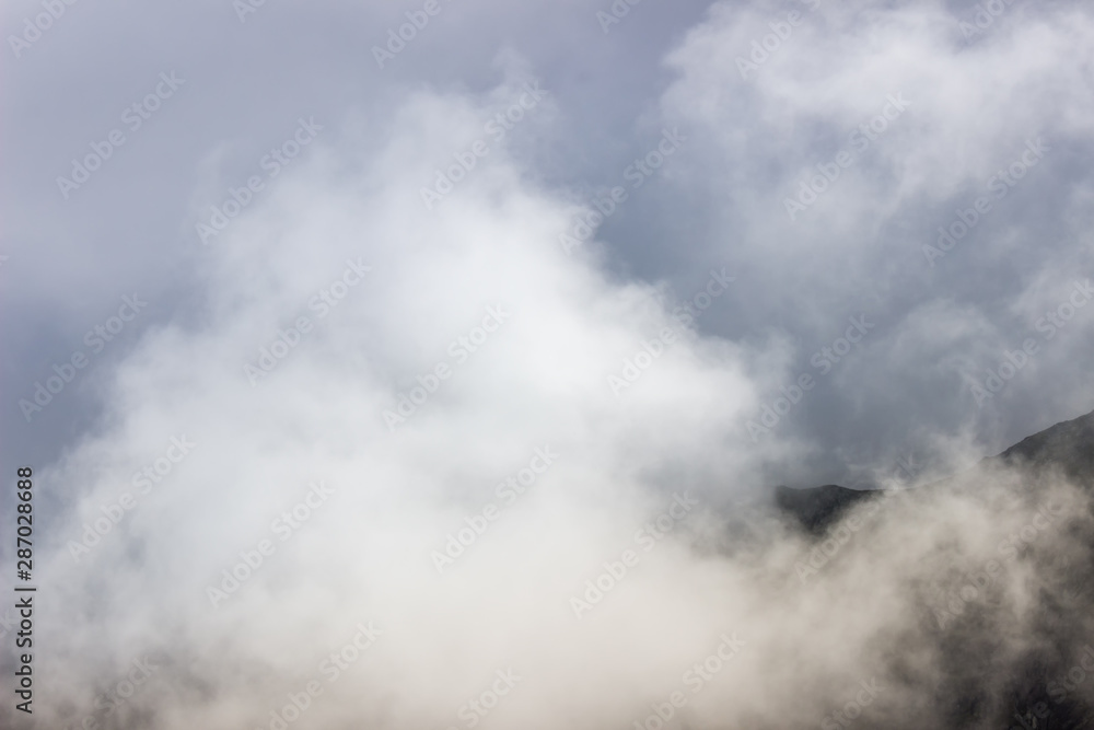 Minimalist, soft view of mist and low clouds covering the highlands of Rila mountain in Bulgaria