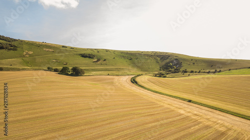 Long Man of Wilmington and the South Downs, England. A summer view of the South Downs countryside with the hill figure visible on the distant hill.