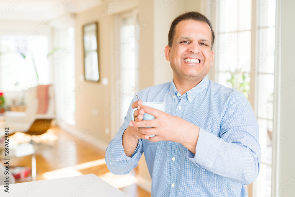 Middle age man enjoying and drinking a cup of coffee at home Middle age man enjoying and drinking a cup of coffee at home