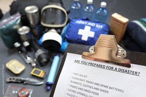 Are you prepared for a disaster?Clipboard checklist.Survival kit would include food,water,lighting,shelter,and first aid kit photo