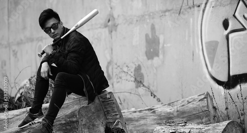 Black White photo of Asian young man outdoors posing