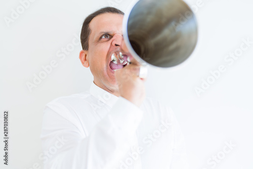 Middle age man shouting through a megaphone