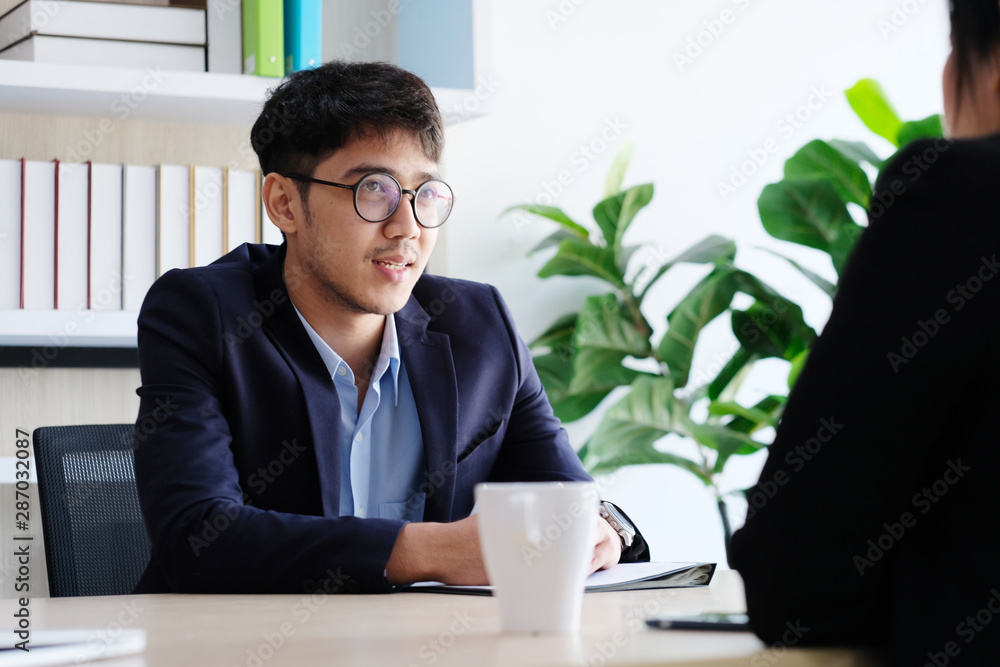 Young asian businessman smiling at business meeting, job interview, in office, business people, office lifestyle concept Young asian businessman smiling at business meeting, job interview, in office, business people, office lifestyle concept