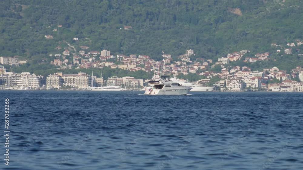 The boat is sailing close by the city of Tivat and Porto Montenegro with luxury yachts The boat is sailing close by the city of Tivat and Porto Montenegro with luxury yachts