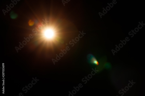 Abstract of sun with flare. Abstract of lighting digital lens fla.  Abstract Festivevintage lights defocused. re in dark background photo