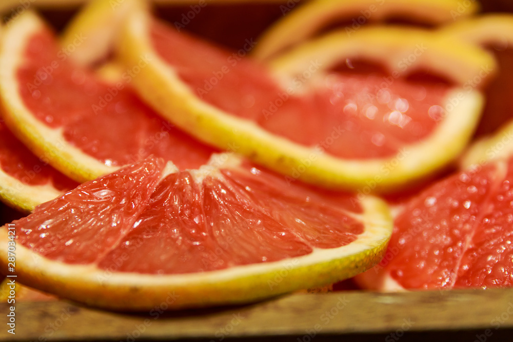 Grapefruit slices in a wooden bowl ready to be used in a cocktail Grapefruit slices in a wooden bowl ready to be used in a cocktail