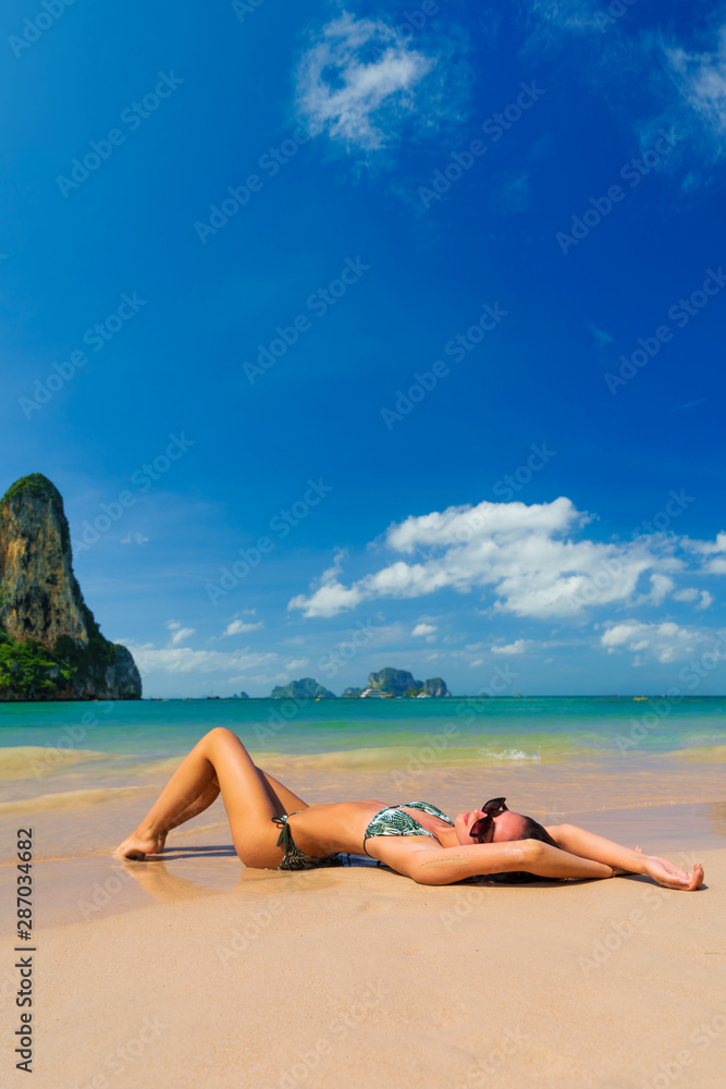 Cute woman relaxing on the summer beach. Cute woman relaxing on the summer beach.