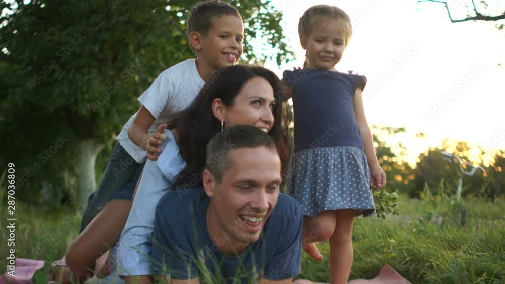 Big family with three children have fun playing and lounging on the grass in the countryside. Happy family vacation Big family with three children have fun playing and lounging on the grass in the countryside. Happy family vacation