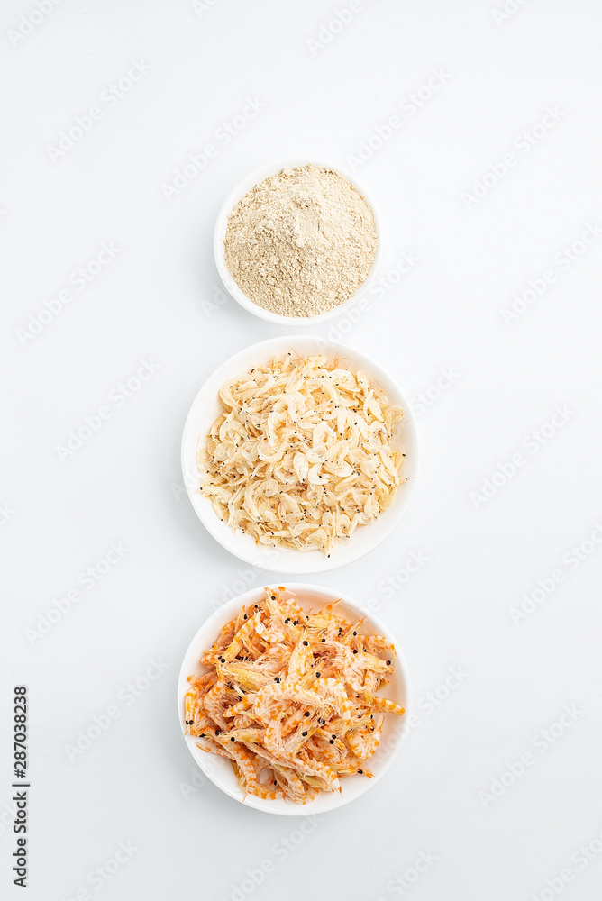 Dried seafood white shrimp and shrimp skin powder on white background Dried seafood white shrimp and shrimp skin powder on white background