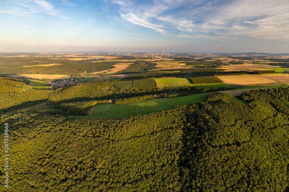 Aerial view at a landscape in Germany, Rhineland Palatinate near Bad Sobernheim with trees, meadow, farmland, forest, hills, mountains