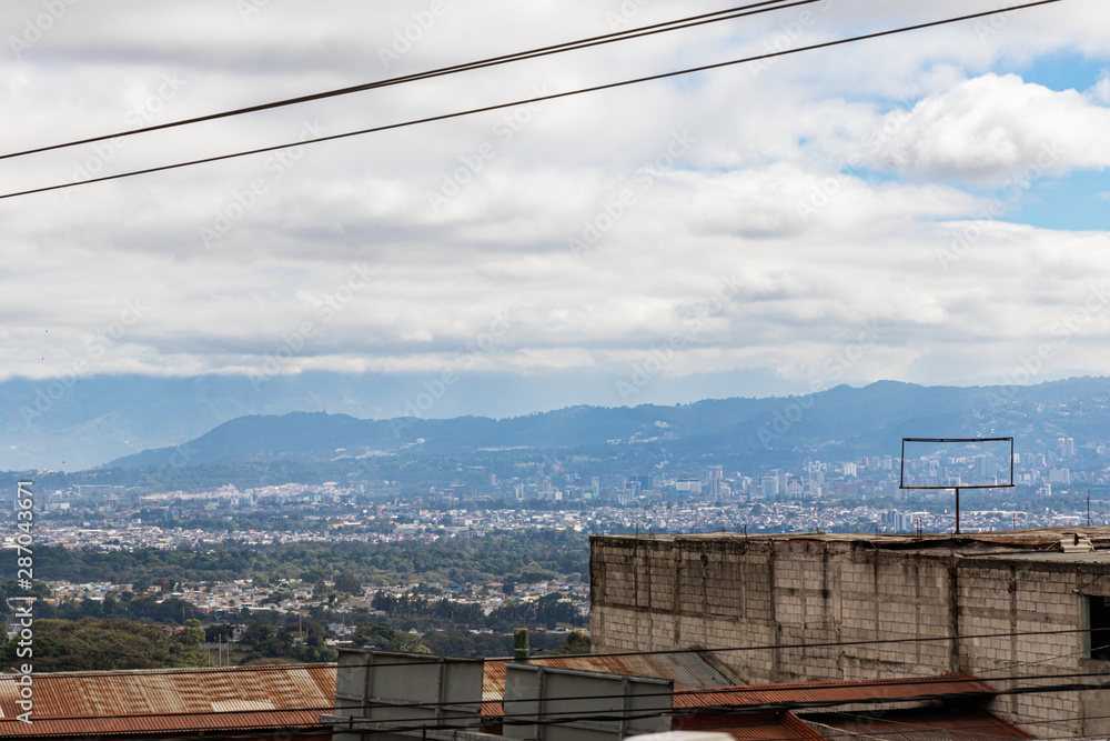 GUATEMALA CITY, GUATEMALA - December 23, 2018: A Panoramic view of Guatemala City on the road from Antigua. GUATEMALA CITY, GUATEMALA - December 23, 2018: A Panoramic view of Guatemala City on the road from Antigua.