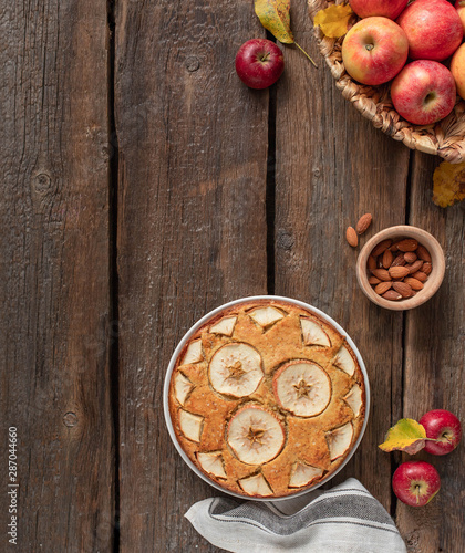 homemade apple pie on a wooden rustic background, top view