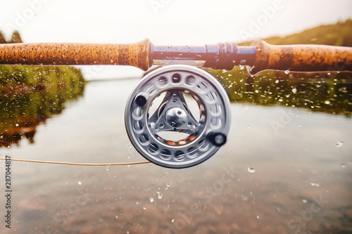 Coil of fly fishing rope, man hands holding rod photo