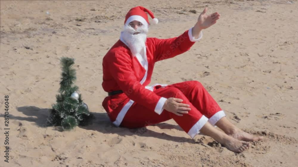 santa claus is sitting on the beach welcomes celebration christmas new year santa claus is sitting on the beach welcomes celebration christmas new year