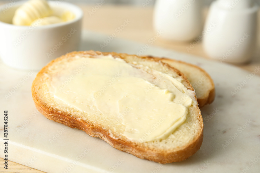 Tasty bread with butter for breakfast on marble board Tasty bread with butter for breakfast on marble board