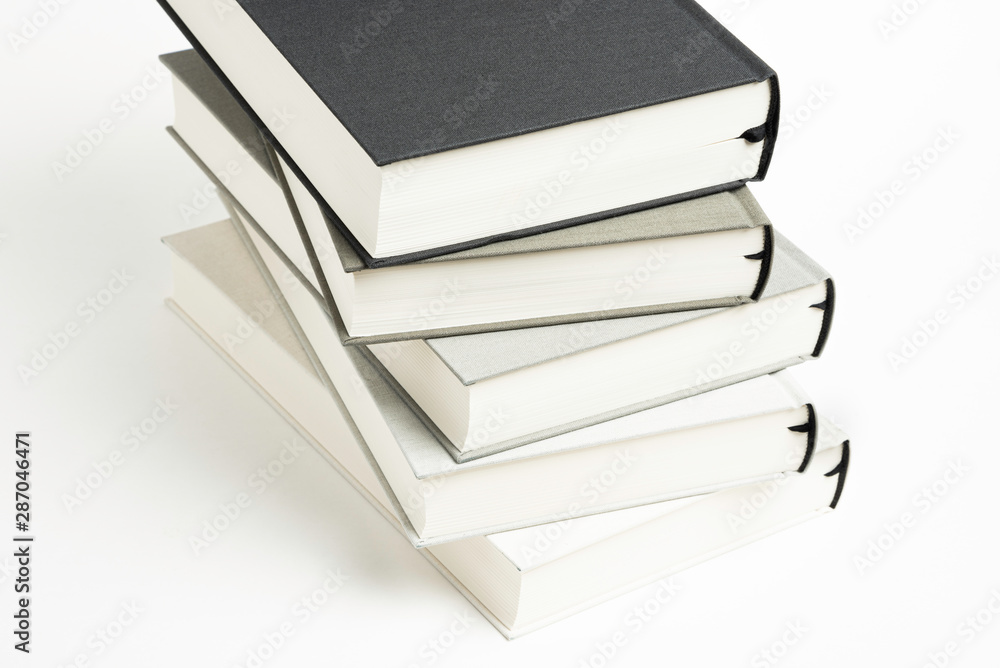A Disarrayed Stack OF Monochromatic Cloth Bound Books Set On White Background A Disarrayed Stack OF Monochromatic Cloth Bound Books Set On White Background