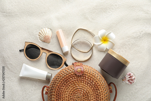 Canvas Print Flat lay composition with sun protection cosmetic products on sand, space for te