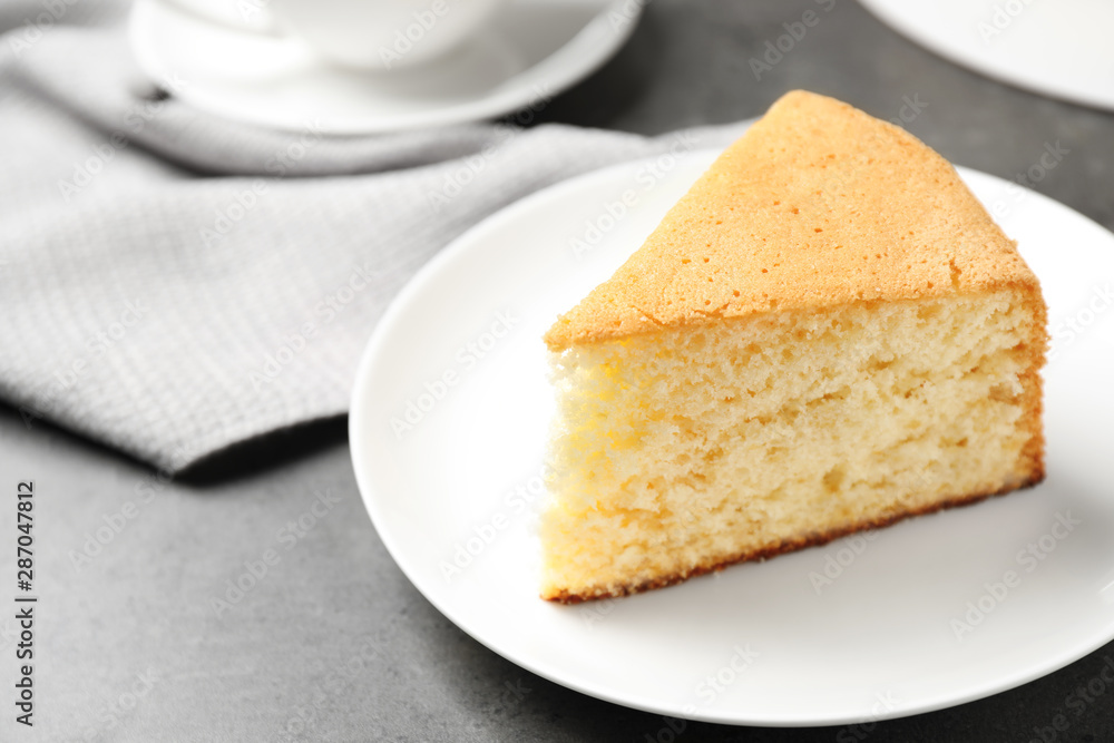 Piece of delicious fresh homemade cake on grey table Piece of delicious fresh homemade cake on grey table