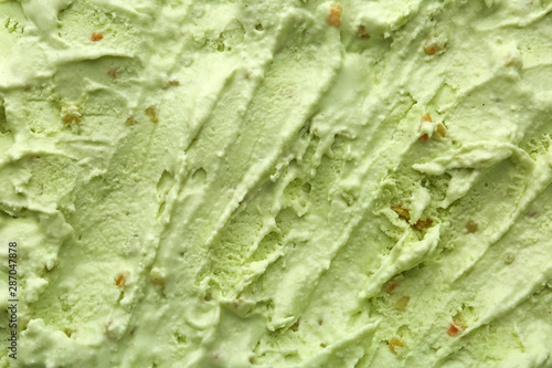 Delicious refreshing pistachio ice cream as background, closeup photo