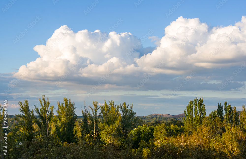 Autumn urban landscape on a Sunny day - yellow autumn trees and bright sky with clouds Autumn urban landscape on a Sunny day - yellow autumn trees and bright sky with clouds