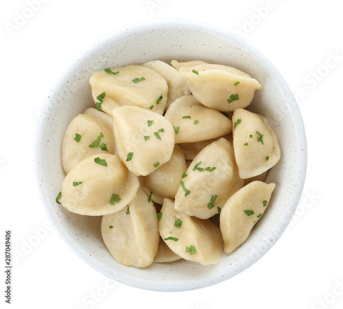 Bowl of delicious cooked dumplings on white background, top view