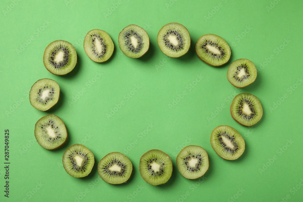 Frame made of fresh kiwis on green background, top view. Space for text Frame made of fresh kiwis on green background, top view. Space for text