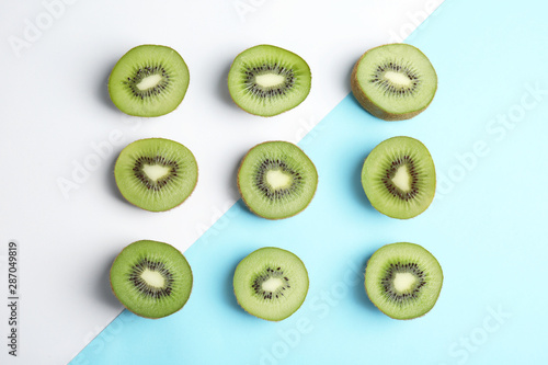 Top view of sliced fresh kiwis on color background