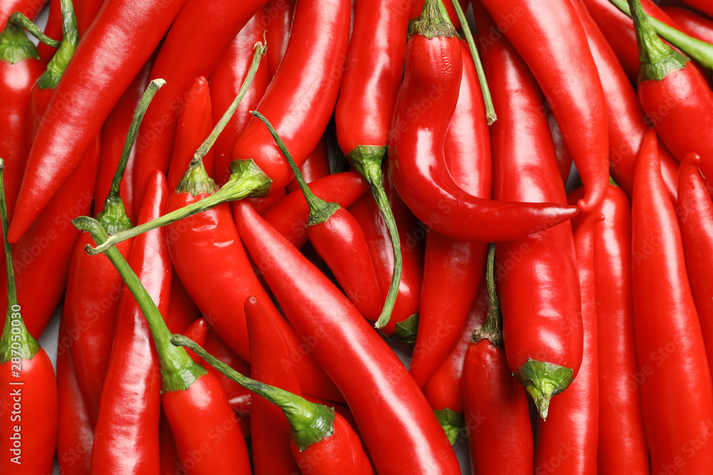 Ripe red chili peppers as background, top view
