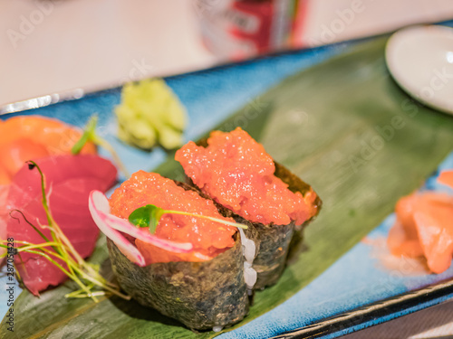 Typical Japanese dish of sushimi and onighiri on a leaf of bamboo. photo