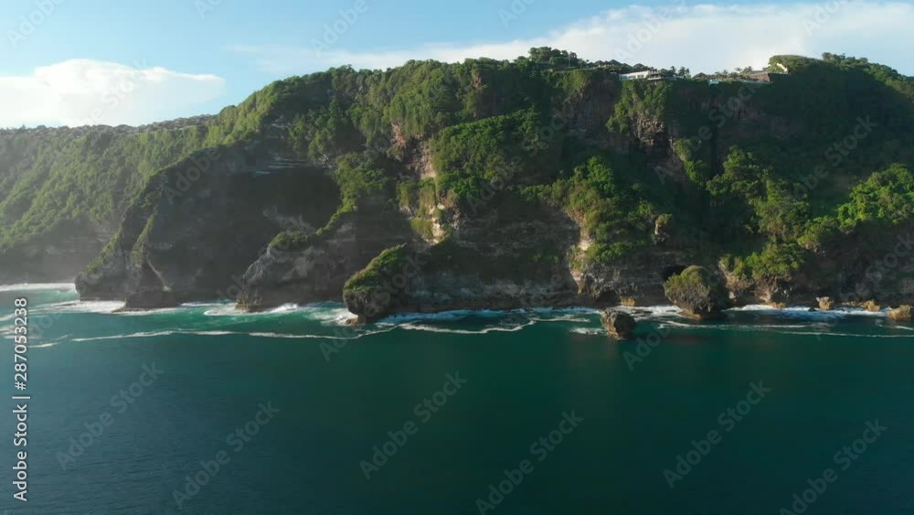 Amazing cliff with rocks and blue ocean in Bali. Aerial view Amazing cliff with rocks and blue ocean in Bali. Aerial view