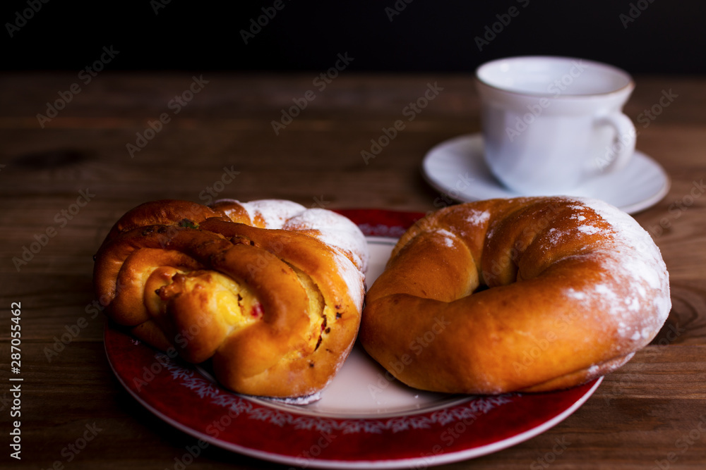 Sweet donut and cup of tea on a wooden table Sweet donut and cup of tea on a wooden table