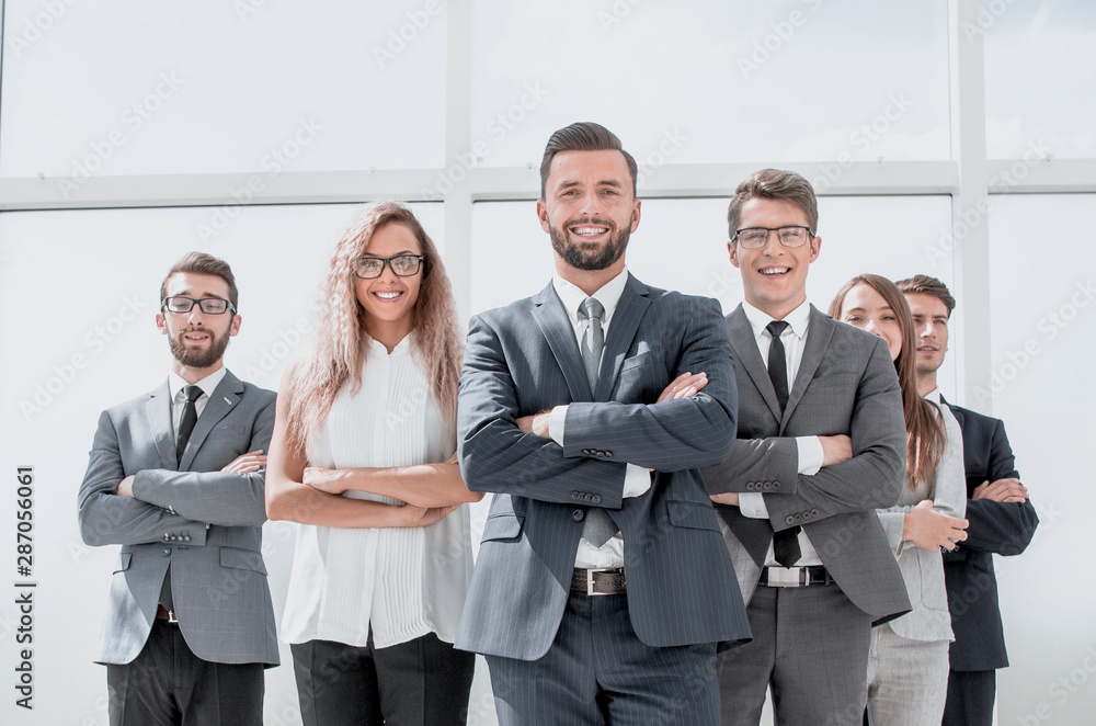 leader and business team standing in spacious office leader and business team standing in spacious office