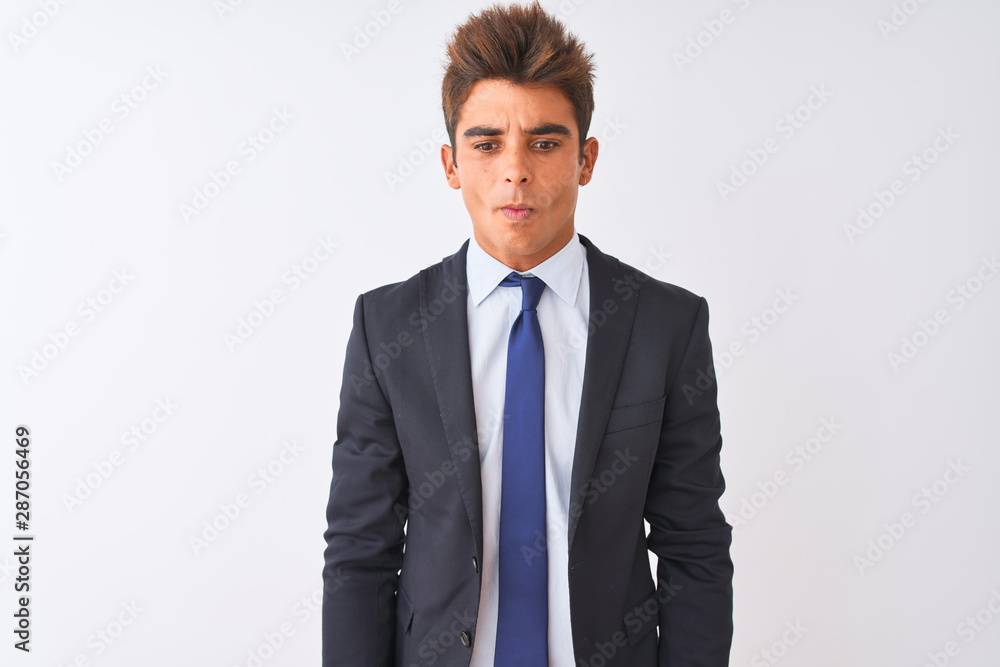 Young handsome businessman wearing suit standing over isolated white background making fish face with lips, crazy and comical gesture. Funny expression. Young handsome businessman wearing suit standing over isolated white background making fish face with lips, crazy and comical gesture. Funny expression.